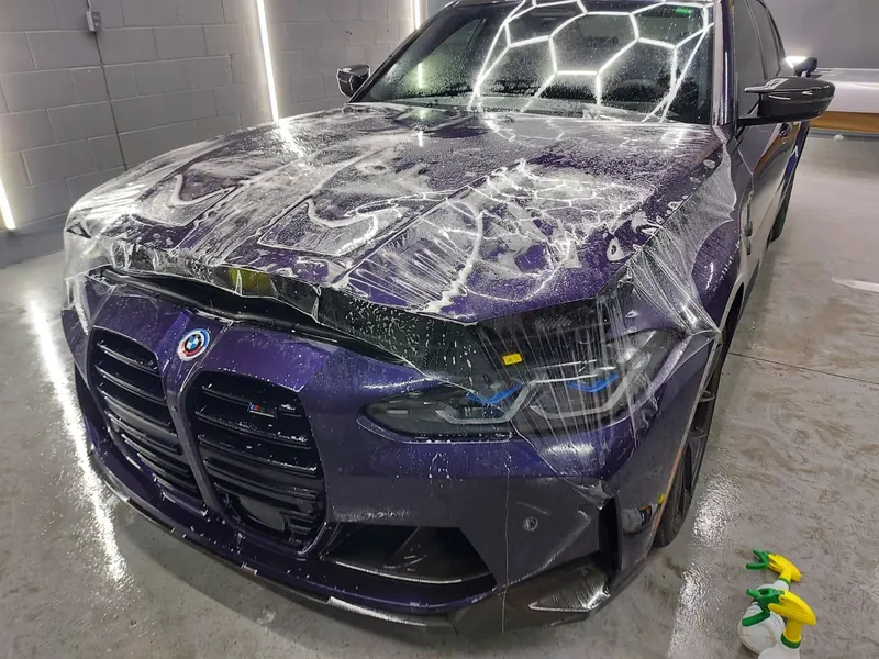 Car being fitted with clear paint protection film