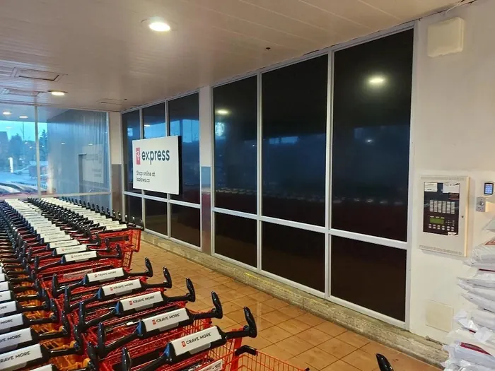 The same store glass wall after blackout film, now solid black