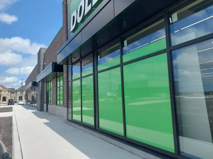 Store windows in Milton covered with green graphic window film