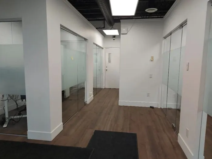 Office hallway with frosted privacy film on glass doors